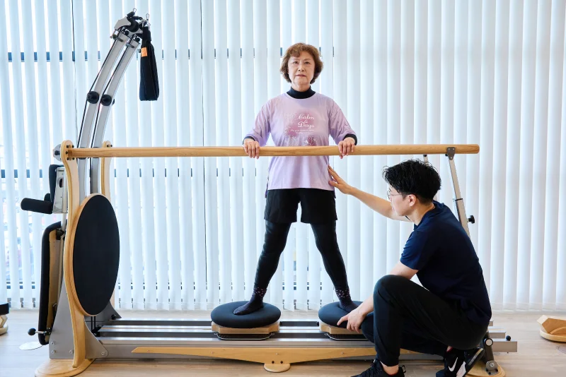 身体の状態チェックを受ける女性と評価する理学療法士